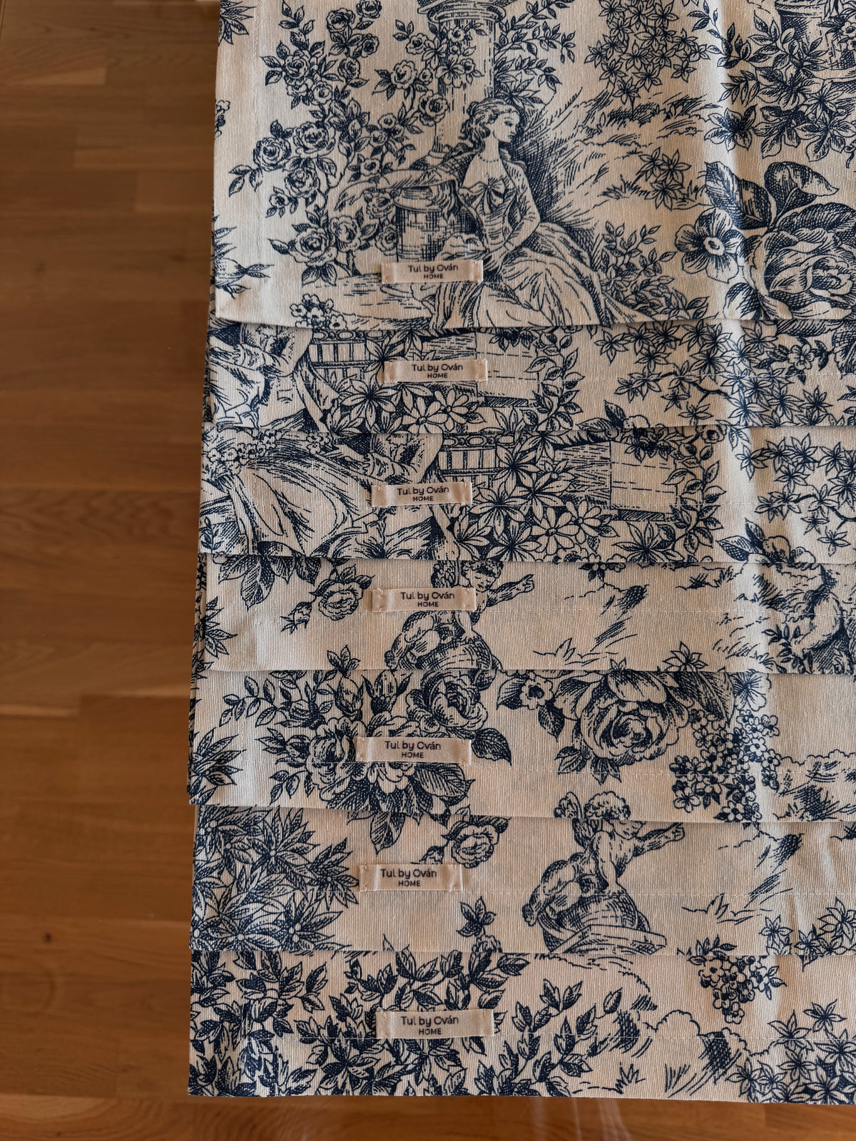 Navy blue toile print fabric table runner on wooden floor