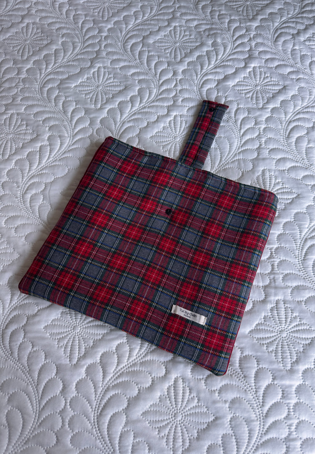 Red and grey plaid fabric potholder with hanging loop